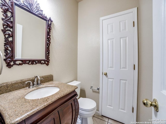 bathroom featuring tile patterned floors, toilet, and vanity