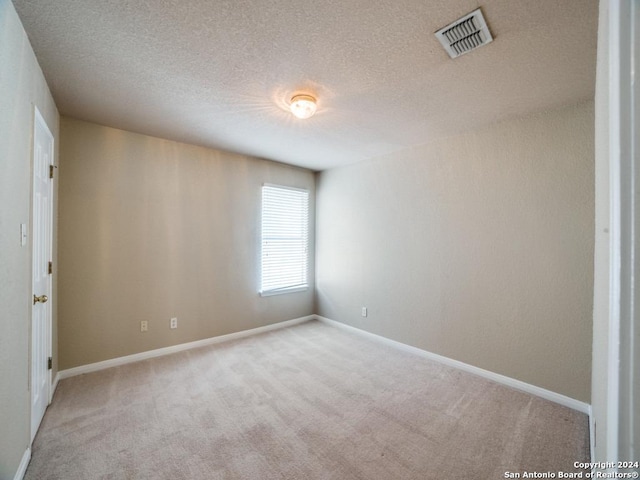 carpeted spare room featuring a healthy amount of sunlight