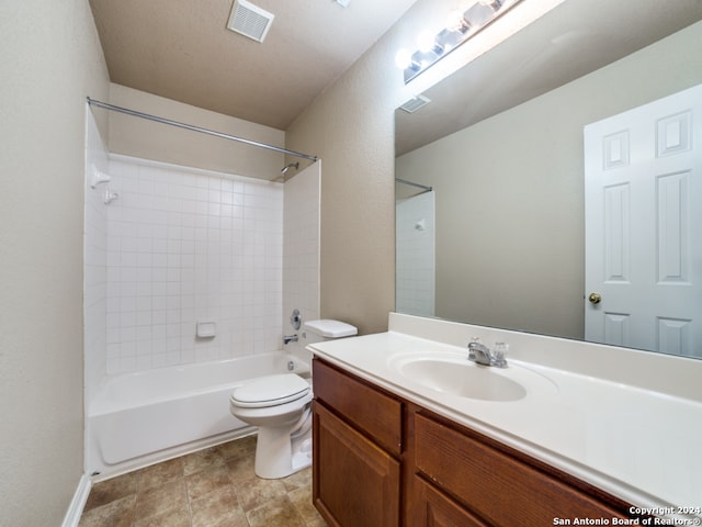 full bathroom with vanity, toilet, and tiled shower / bath