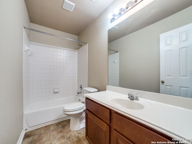 full bathroom featuring tiled shower / bath combo, vanity, and toilet