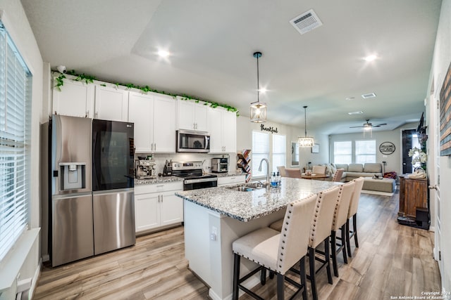 kitchen featuring sink, white cabinetry, light wood-type flooring, appliances with stainless steel finishes, and ceiling fan