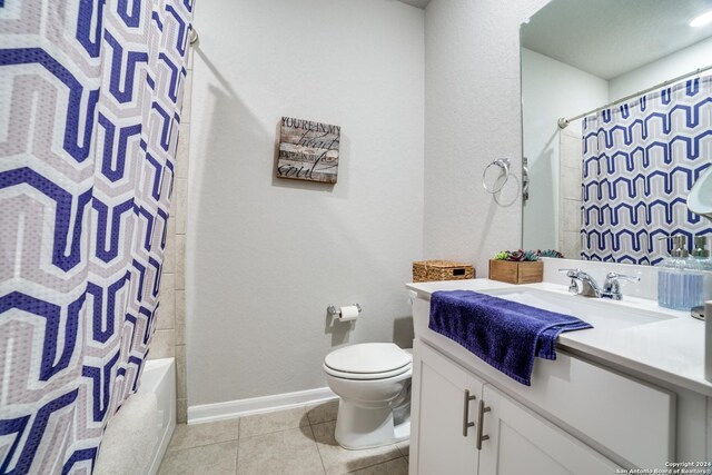 full bathroom with tile patterned flooring, shower / tub combo with curtain, toilet, and vanity