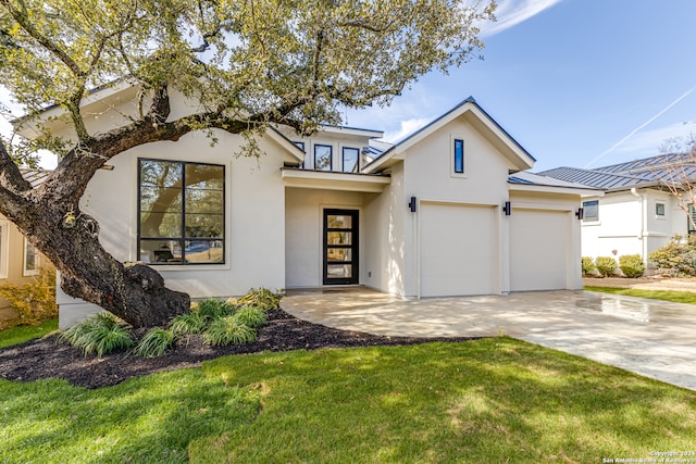 view of front of home with a garage and a front lawn