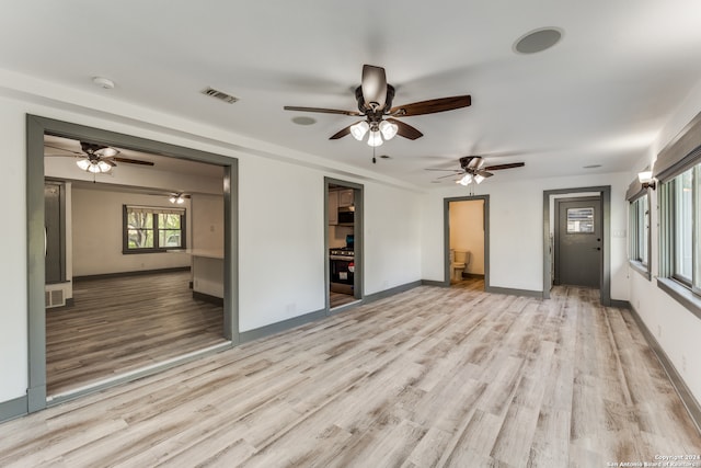 empty room featuring ceiling fan and light hardwood / wood-style floors