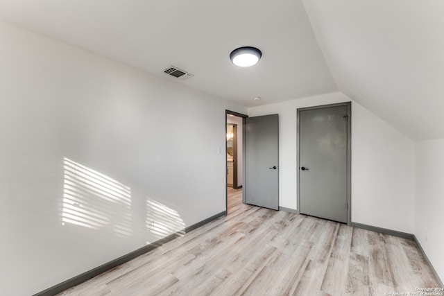 bonus room featuring lofted ceiling and light hardwood / wood-style flooring