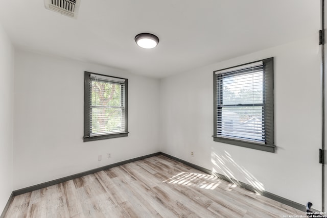 unfurnished room with light hardwood / wood-style floors