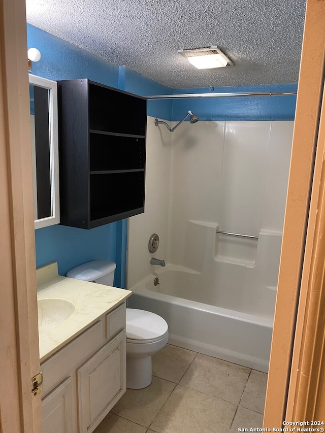 full bathroom featuring shower / tub combination, a textured ceiling, tile patterned flooring, vanity, and toilet