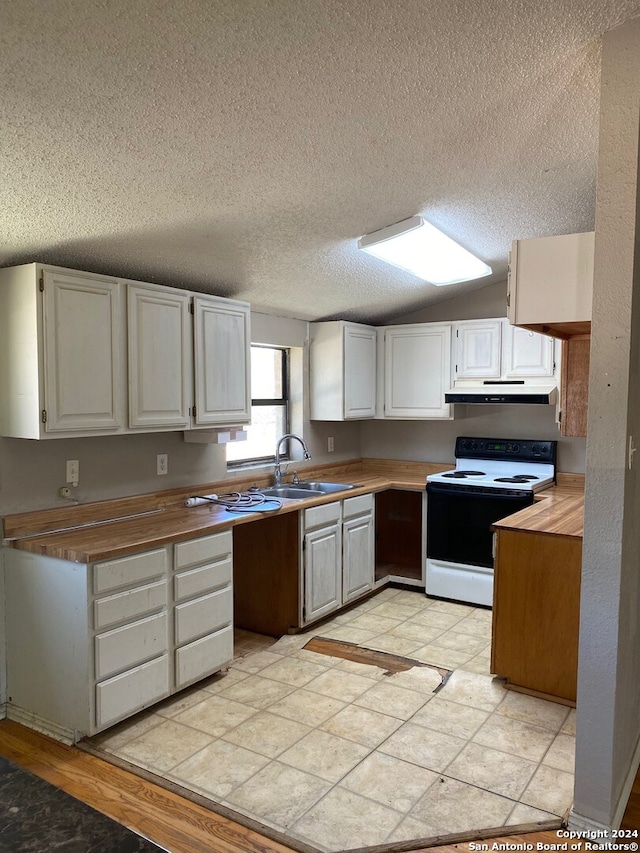 kitchen with white range with electric stovetop, white cabinets, light tile patterned floors, sink, and a textured ceiling