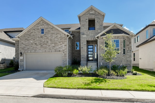 view of front facade with a garage and a front yard