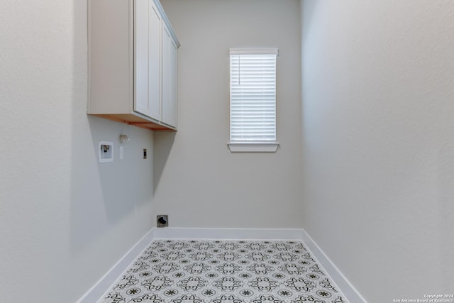laundry area with washer hookup, baseboards, electric dryer hookup, and cabinet space
