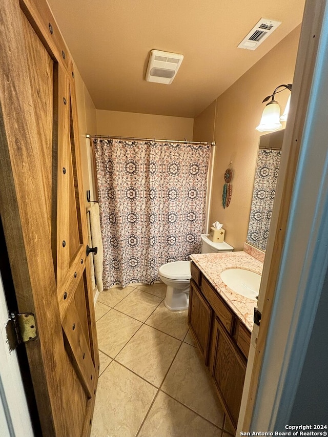 bathroom featuring vanity, toilet, and tile patterned flooring