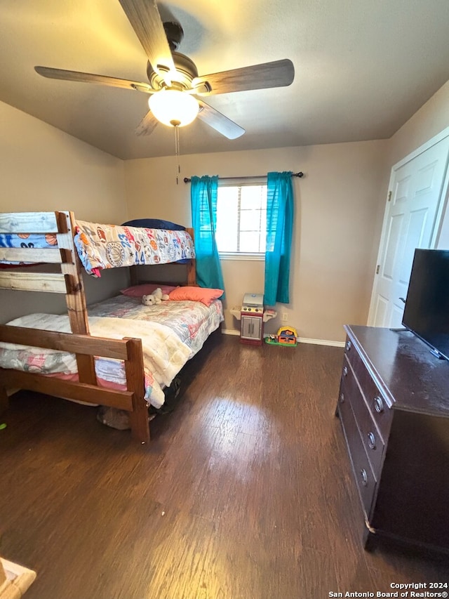 bedroom with ceiling fan and dark hardwood / wood-style floors