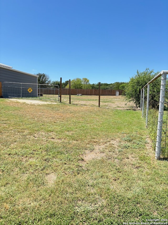 view of yard with a rural view