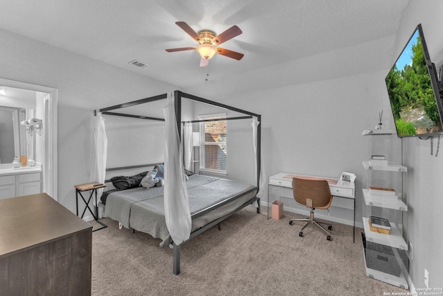 bedroom with light carpet, visible vents, baseboards, ceiling fan, and a textured ceiling