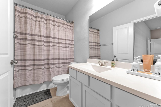 bathroom featuring toilet, shower / bath combo with shower curtain, vanity, and tile patterned floors