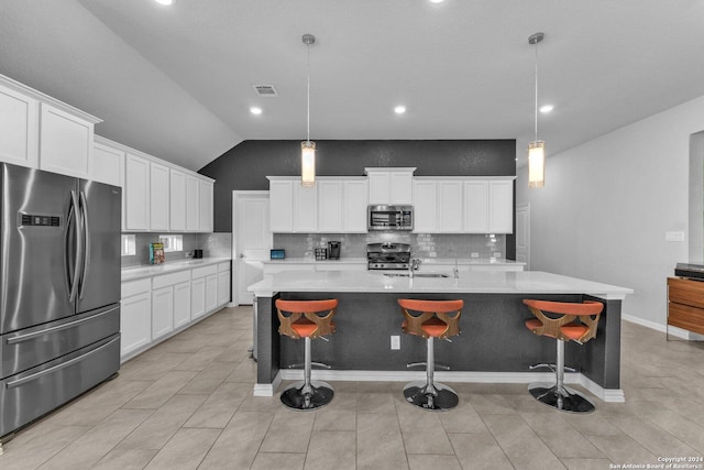 kitchen with stainless steel appliances, a large island, light countertops, and decorative light fixtures