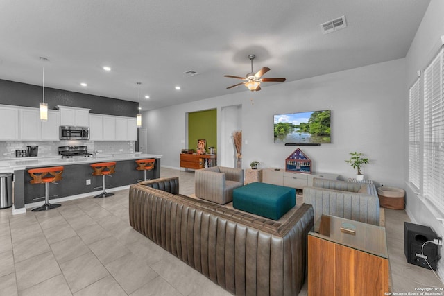 living area featuring recessed lighting, visible vents, ceiling fan, and light tile patterned floors