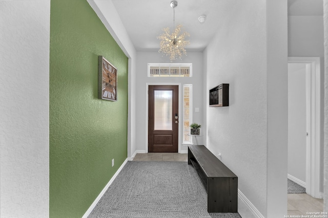 doorway to outside featuring light carpet and a notable chandelier