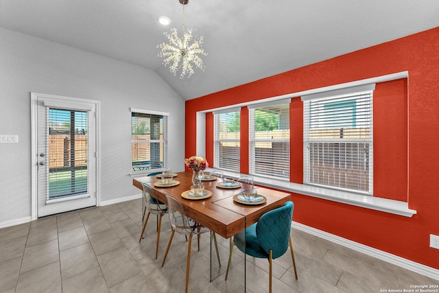 tiled dining room with vaulted ceiling, an inviting chandelier, baseboards, and a healthy amount of sunlight