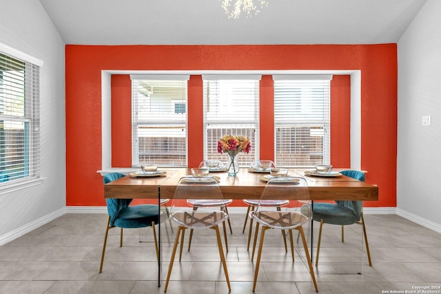 dining room featuring plenty of natural light, light tile patterned flooring, and baseboards