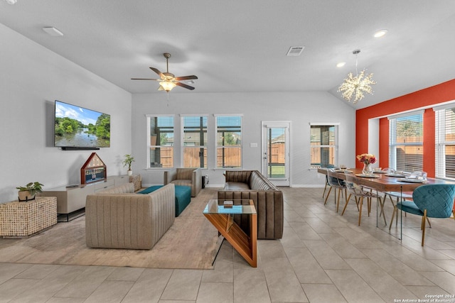 living room featuring ceiling fan with notable chandelier, plenty of natural light, lofted ceiling, and visible vents