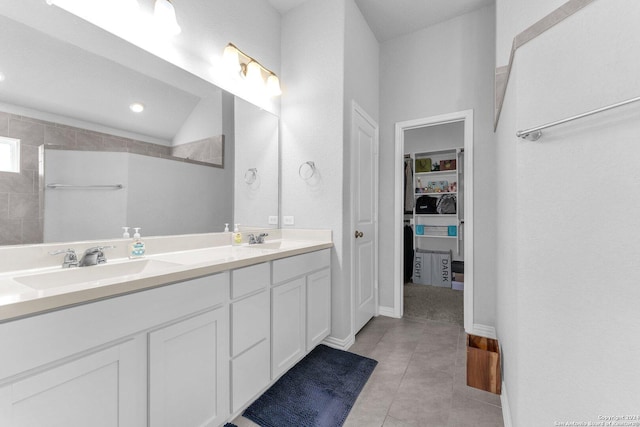 bathroom featuring a sink, double vanity, tile patterned flooring, and lofted ceiling