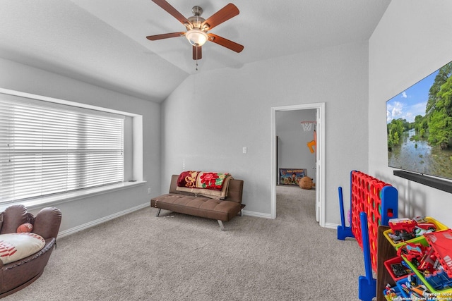 living area with carpet, ceiling fan, lofted ceiling, and baseboards