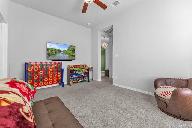 carpeted living room featuring baseboards, visible vents, and a ceiling fan