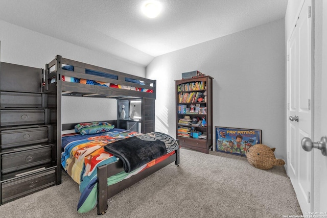 bedroom featuring lofted ceiling and carpet