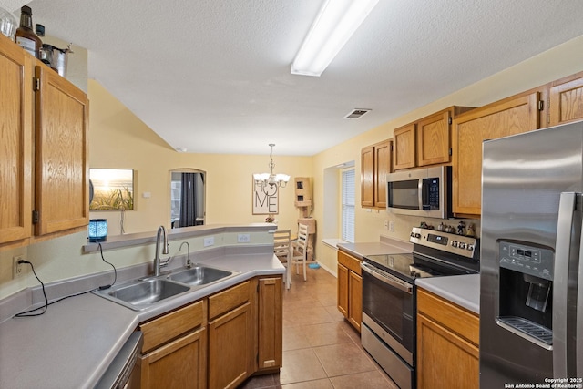 kitchen with sink, decorative light fixtures, a chandelier, light tile patterned floors, and appliances with stainless steel finishes