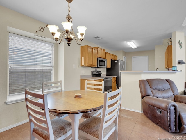 tiled dining space featuring a notable chandelier