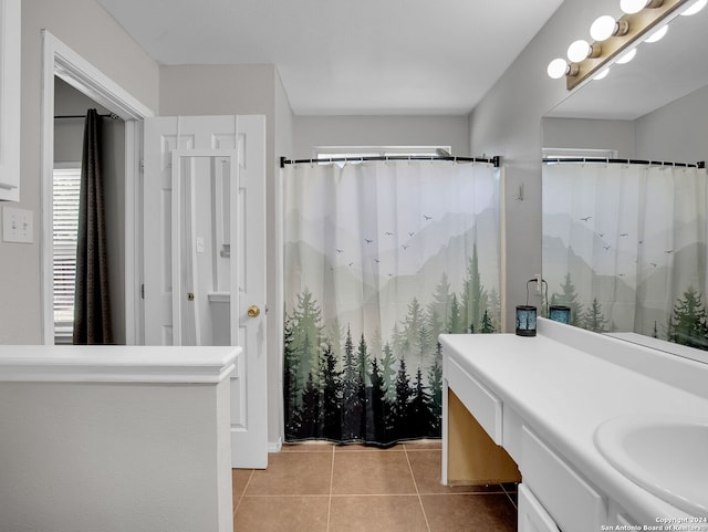 bathroom with vanity, curtained shower, and tile patterned floors