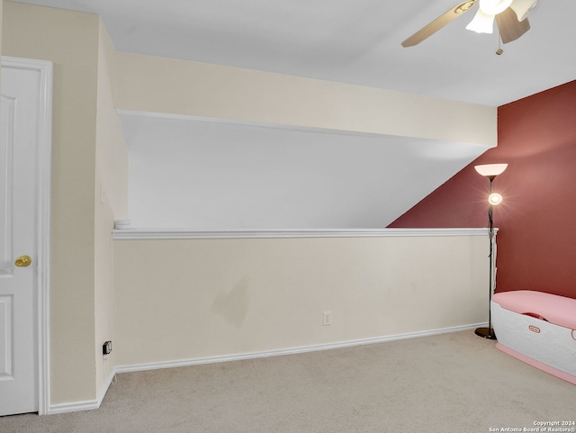 unfurnished bedroom featuring ceiling fan, carpet flooring, and lofted ceiling