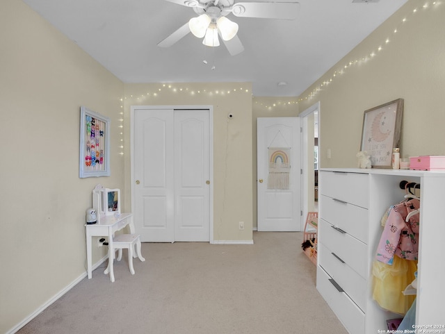 interior space featuring ceiling fan and a closet