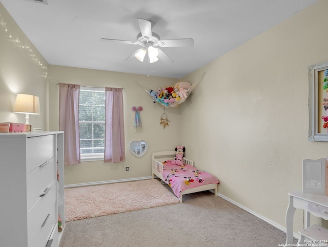 bedroom with ceiling fan and light carpet