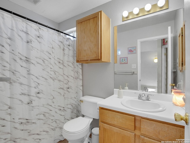 bathroom featuring vanity, a shower with curtain, and toilet