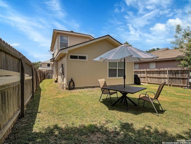 rear view of property with a yard