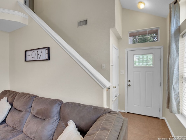 tiled foyer featuring a high ceiling