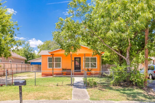 bungalow-style home with a front yard