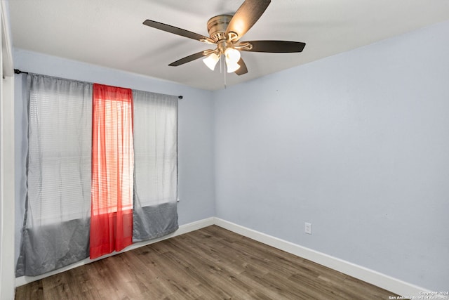 empty room with hardwood / wood-style floors and ceiling fan