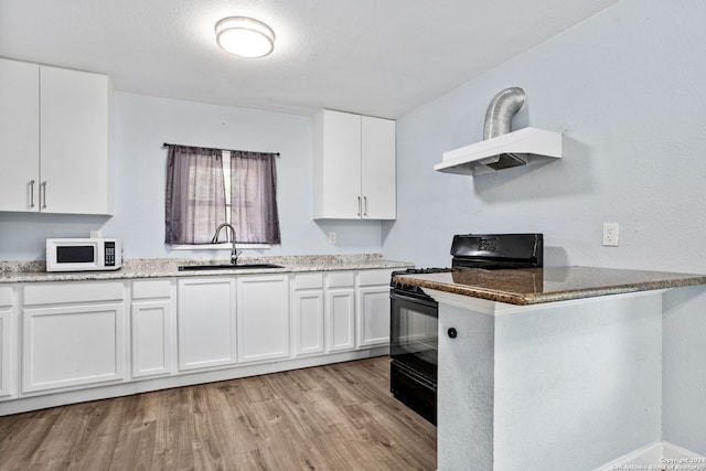 kitchen featuring black range with electric stovetop, sink, light wood-type flooring, and white cabinets