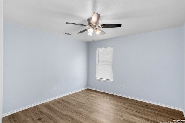 spare room featuring ceiling fan and hardwood / wood-style flooring