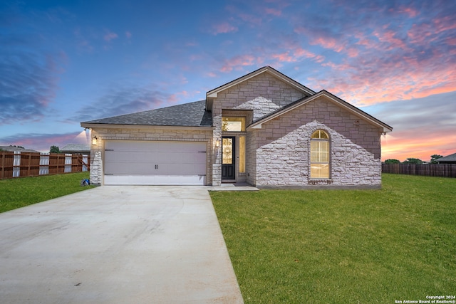 view of front facade with a lawn and a garage