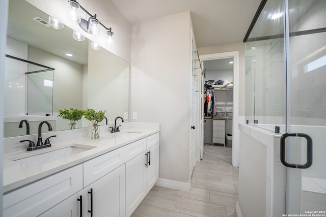 bathroom with double sink vanity and tile patterned floors