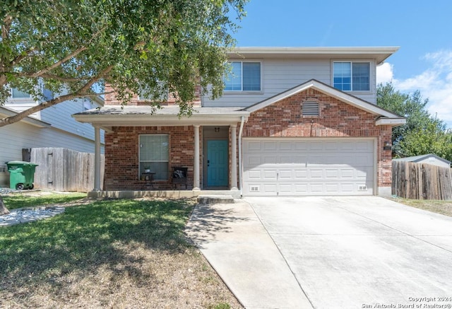 view of property with a front lawn and a garage