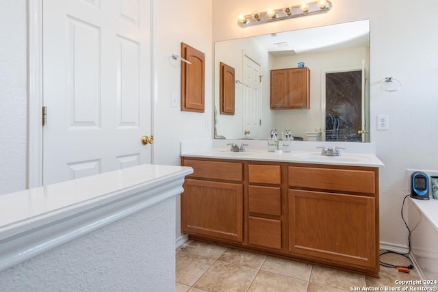 bathroom featuring tile patterned floors and dual bowl vanity