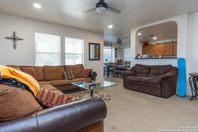 carpeted living room featuring ceiling fan