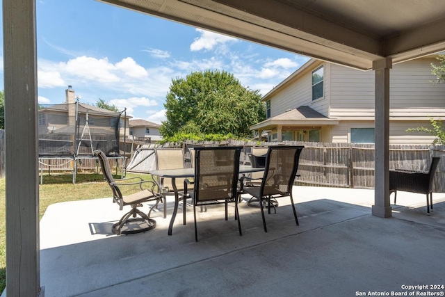 3802 Blue Oak Pass, San Antonio, TX 78223 - view of patio / terrace featuring outdoor dining area, a fenced backyard, and a trampoline
