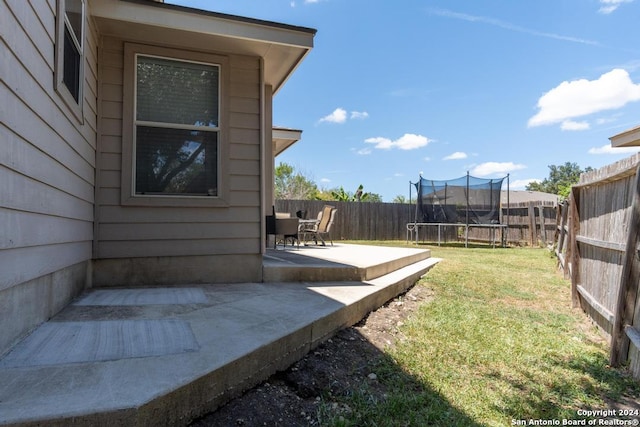 3802 Blue Oak Pass, San Antonio, TX 78223 - view of yard featuring a fenced backyard, a trampoline, and a patio area