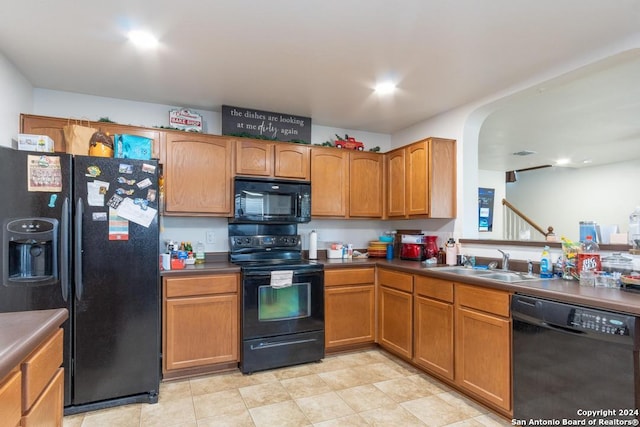 3802 Blue Oak Pass, San Antonio, TX 78223 - kitchen with a sink, brown cabinets, black appliances, and dark countertops